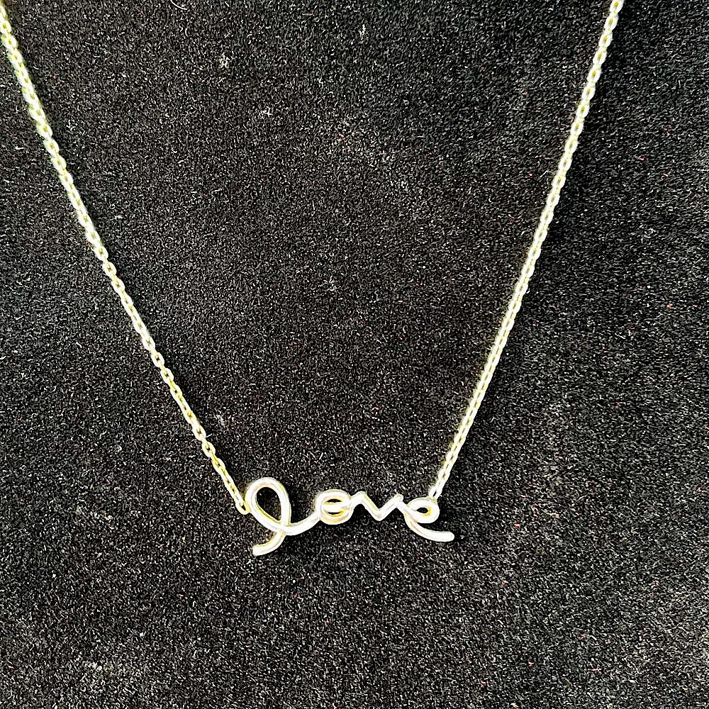 Silver necklace with cursive love
